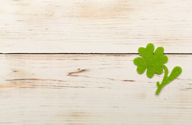 istock Felt clover on wooden background, top view. St. Patricks day concept 1500799962