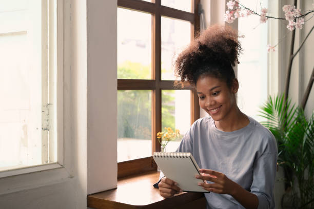 istock African American female freelancer checking work plan in personal daily planner. 1500800962