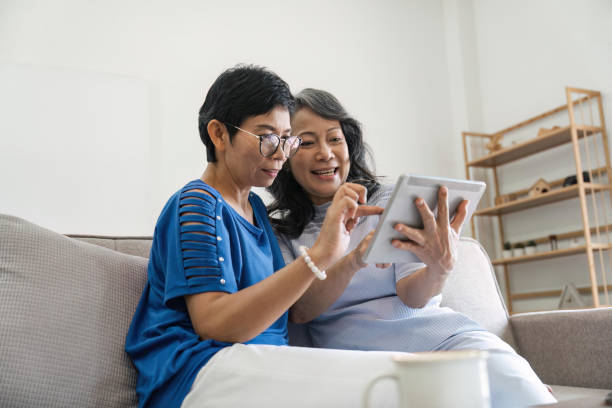 istock Senior female friend using digital tablet together 1500801365