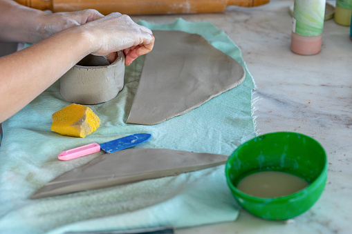 Hands make an earthenware cup