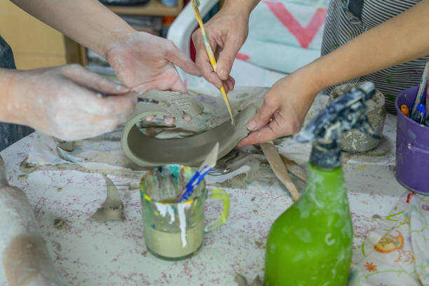 istock Teamwork, teaching and artist with a helper for crafts 1500802081