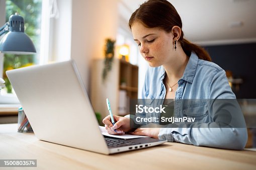 istock Teenage girl doing homework 1500803574
