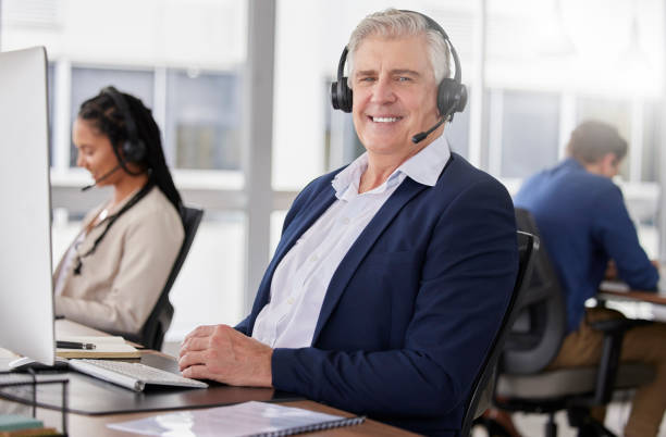 istock Call center portrait, happy or friendly man in communication, speaking or talking to help with customer services. Smile, crm or mature sales agent with microphone in crm technical support office 1500804050