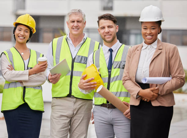 istock Construction site, portrait and team at a building for planning, creative and collaboration. Architecture, business people and designer group with blueprint, documents or engineering development plan 1500804056