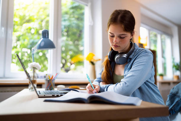 istock Teenage girl doing homework 1500804796