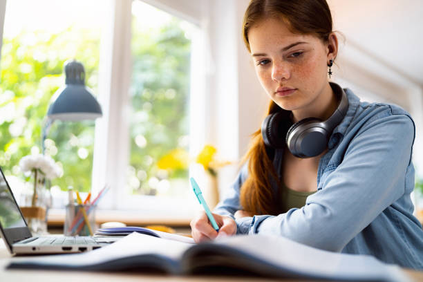 istock Teenage girl doing homework 1500805101