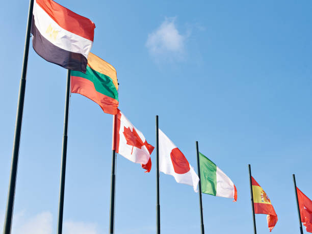 istock Canada, Japan, Italy, Spain, Lithuania, Egypt flags on sky 1500805323
