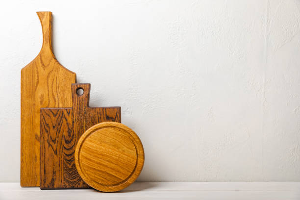 istock Empty wooden board on kitchen white marble table. Cutting board. Wooden cutting board, copy space. Kitchenware. Recipe. Place for text. Flat lay. 1500806700