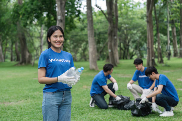 istock Pretty smiling female collecting forest garbage, looking at camera, volunteering 1500807120