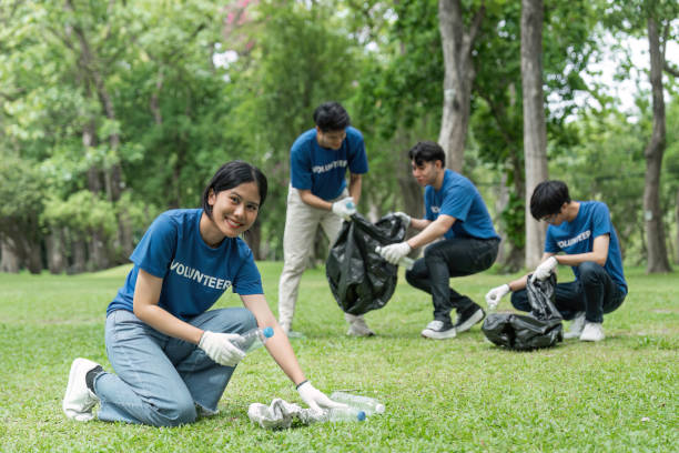 istock Pretty smiling female collecting forest garbage, looking at camera, volunteering 1500807345
