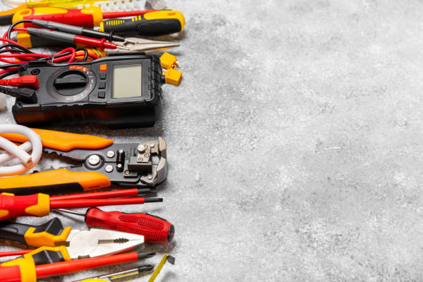 istock Electrician equipment on marble background with copy space.Top view.Electrician tool set.Multimeter, tester,screwdrivers,cutters,duct tape,lamps,tape measure and wires.Flet lay. 1500807627