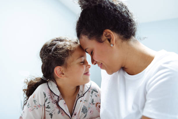 istock Affectionate Latin mother with her daughter in bed 1500808150