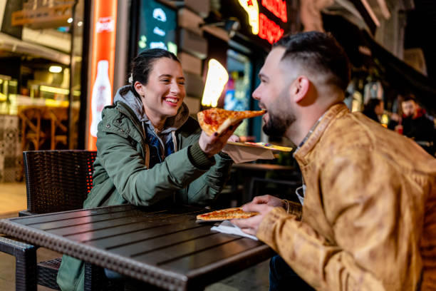 istock Young Couple Sharing a Meal Outdoors 1500809012