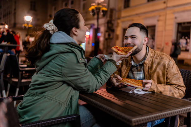 istock Young Couple Enjoying Pizza in a Cozy Outdoor Setting 1500809203