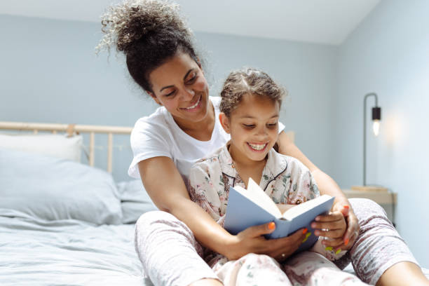 istock Mother is reading an interesting book to her daughter 1500809582