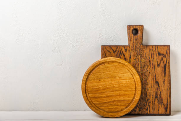 istock Empty wooden board on kitchen white marble table. Cutting board. Wooden cutting board, copy space. Kitchenware. Recipe. Place for text. Flat lay. 1500809694