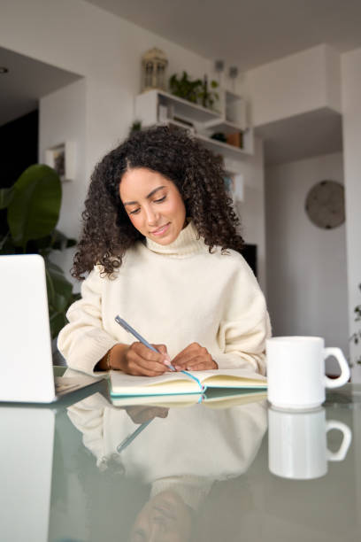 istock Young latin woman student using laptop elearning or working at home. 1500809794