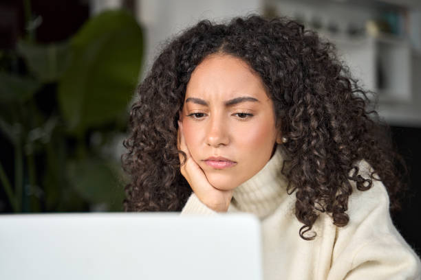 istock Bored latin girl student feeling bored looking at laptop computer. 1500809806