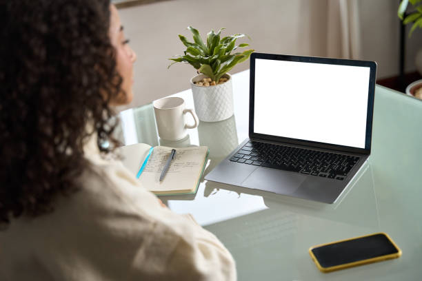 istock Over shoulder view of girl elearning looking at mock up pc laptop screen. 1500809809