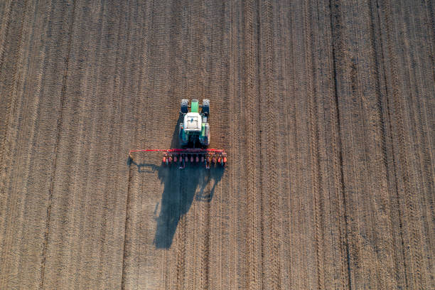 istock Tractor in field, aerial view 1500810839