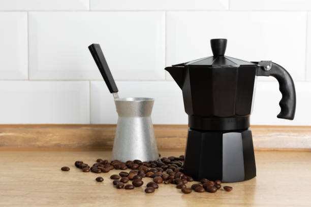 istock Moka pot on the kitchen table. Geyser coffee maker on brown texture background. Morning concept. Morning coffee.Space for copy. Place for text. 1500810943