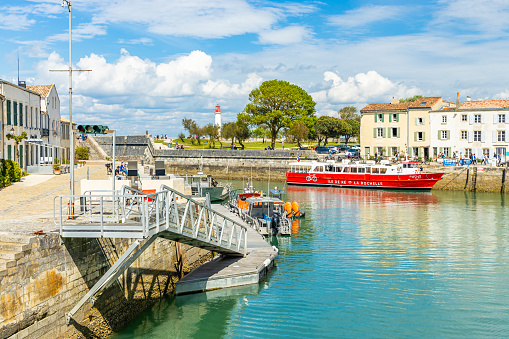 Pier and red shuttle boat connecting the island of Ré and the Old Port of La Rochelle, France