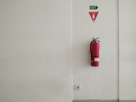 fire extinguisher hanging on the wall, on a white background
