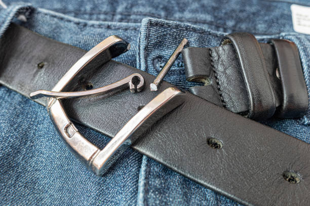 istock Broken metal buckle on a black leather belt. 1500813064