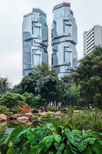 Hong Kong - April 24 2023: Hong Kong Park and Lippo Centre twin-tower skyscrapers located in Admiralty designed by Paul Rudolph