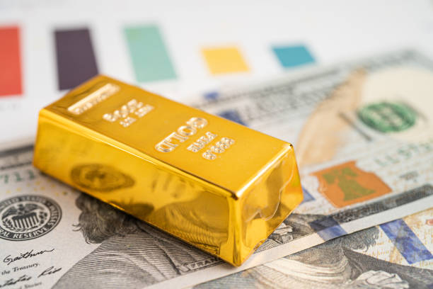 Gold bar on US dollar banknotes money and graph, economy finance exchange trade investment concept. Gold bar on US dollar banknotes money and graph, economy finance exchange trade investment concept. ira precious metals depository stock pictures, royalty-free photos & images