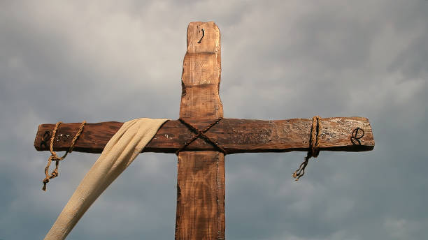 istock Cross with ropes and cloudy sky - detail 1500817508