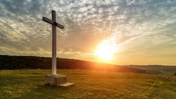istock Cross on the hill at sunset 1500817563