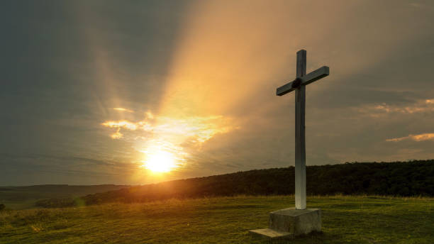 istock Cross on the hill at sunrise 1500818124