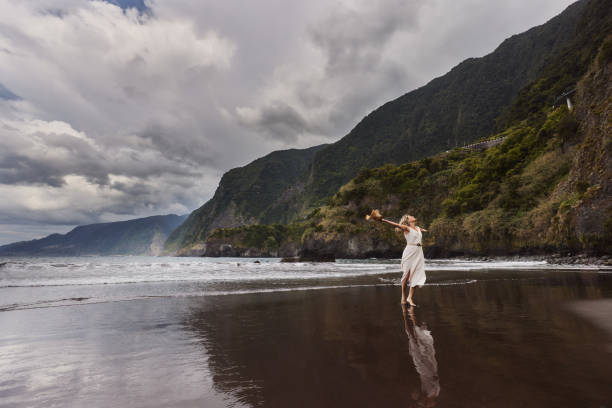istock Happy woman having fun on a black sand beach. 1500818203