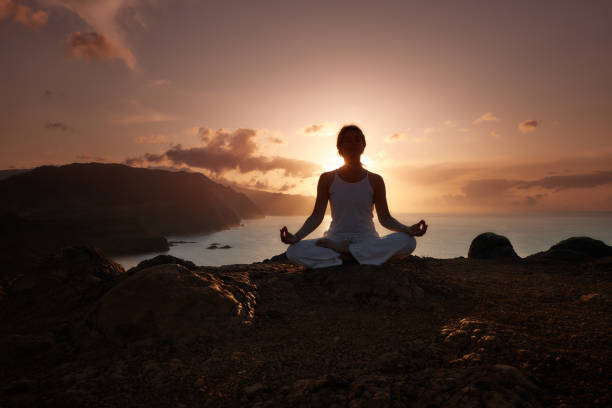 istock Meditating on a cliff above the sea at sunset! 1500819142
