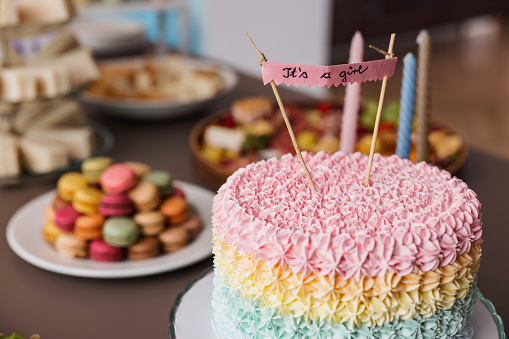 delicious cake with pink whipped cream frosting.