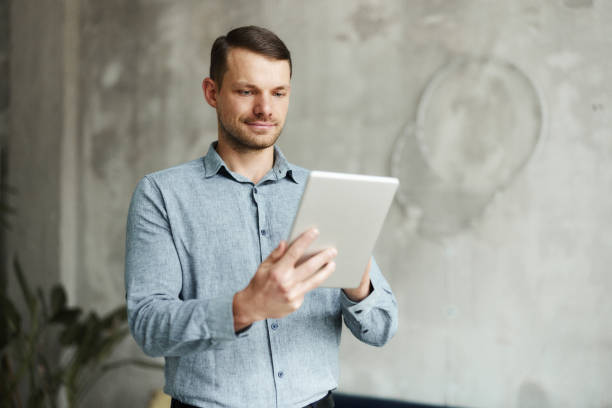 istock Young male entrepreneur working on touchpad in the office. 1500823189