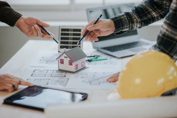 istock Engineer working in office at desk with solar laptop and concept home design Solar Renewable Energy Planning and wind turbine technology business successful work. 1500823367