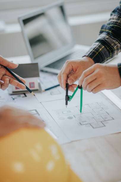 istock Engineer working in office at desk with solar laptop and concept home design Solar Renewable Energy Planning and wind turbine technology business successful work. 1500823399