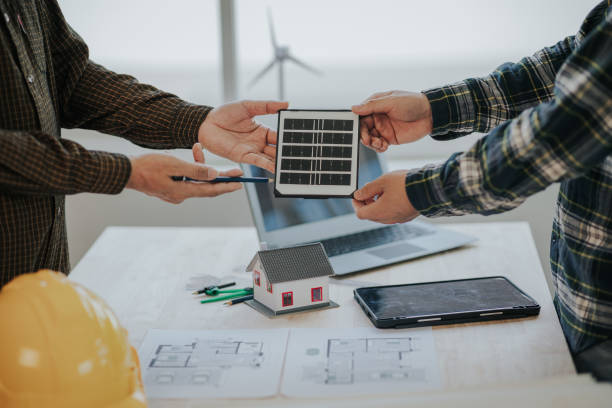istock Engineer working in office at desk with solar laptop and concept home design Solar Renewable Energy Planning and wind turbine technology business successful work. 1500823427