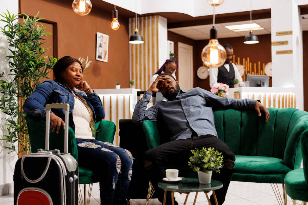 istock Exhausted tourists rest in hotel lobby 1500824310