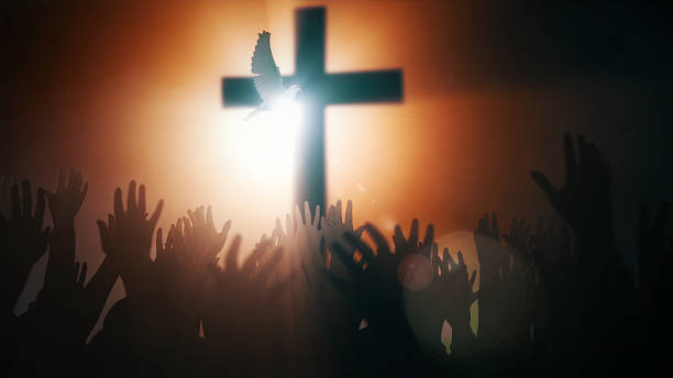 istock Praying hands with Holy Cross and Dove 1500825308