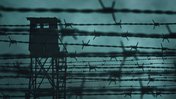 Prison barbed wire and a watchtower