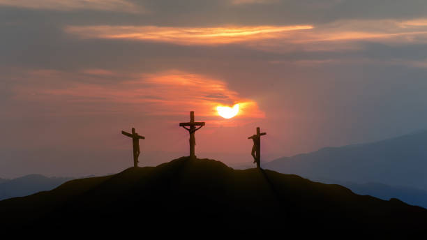 Silhouettes of three crosses at sunset