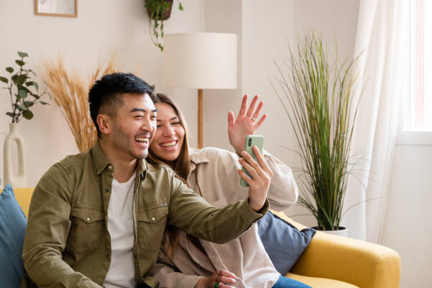 istock Multiracial couple using mobile phone for video call. 1500825674