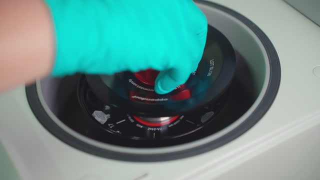 wrap the hands of the scientist in protective gloves, connect an Eppendorf tube or other small tube to a mini centrifuge for solution separation, and then close the station.