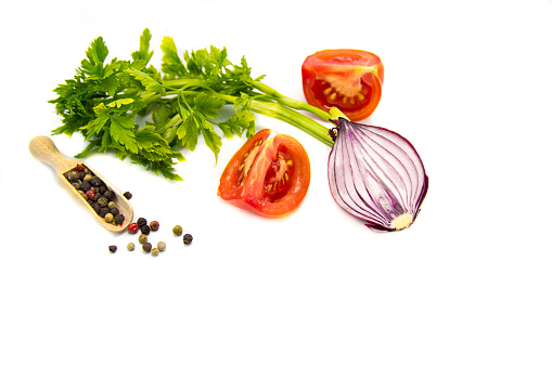 various colorful tomatoes and basil leaves isolated on white background