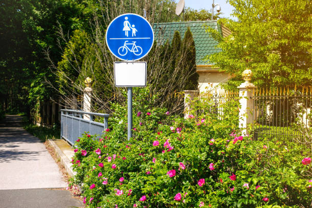 istock Road sign cycle and pedestrian pathway against greenery 1500828379