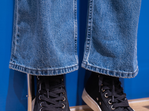 Close-up of jeans and sneakers