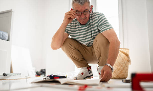 istock Senior handyman assembling wooden furniture 1500836421